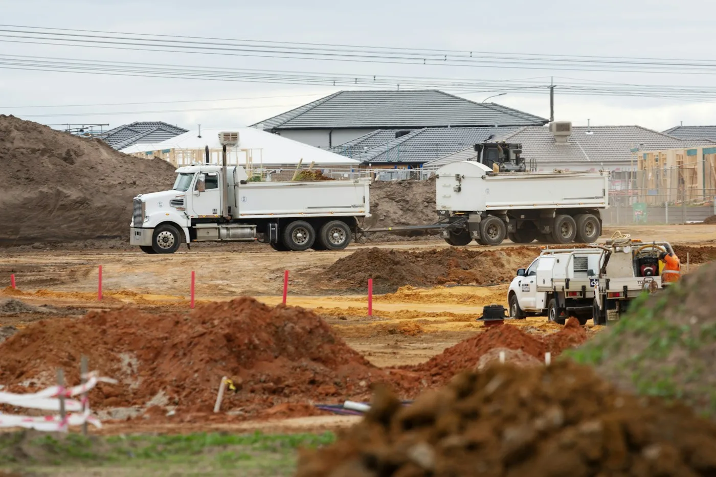 Earthmoving work beside a partially built structure